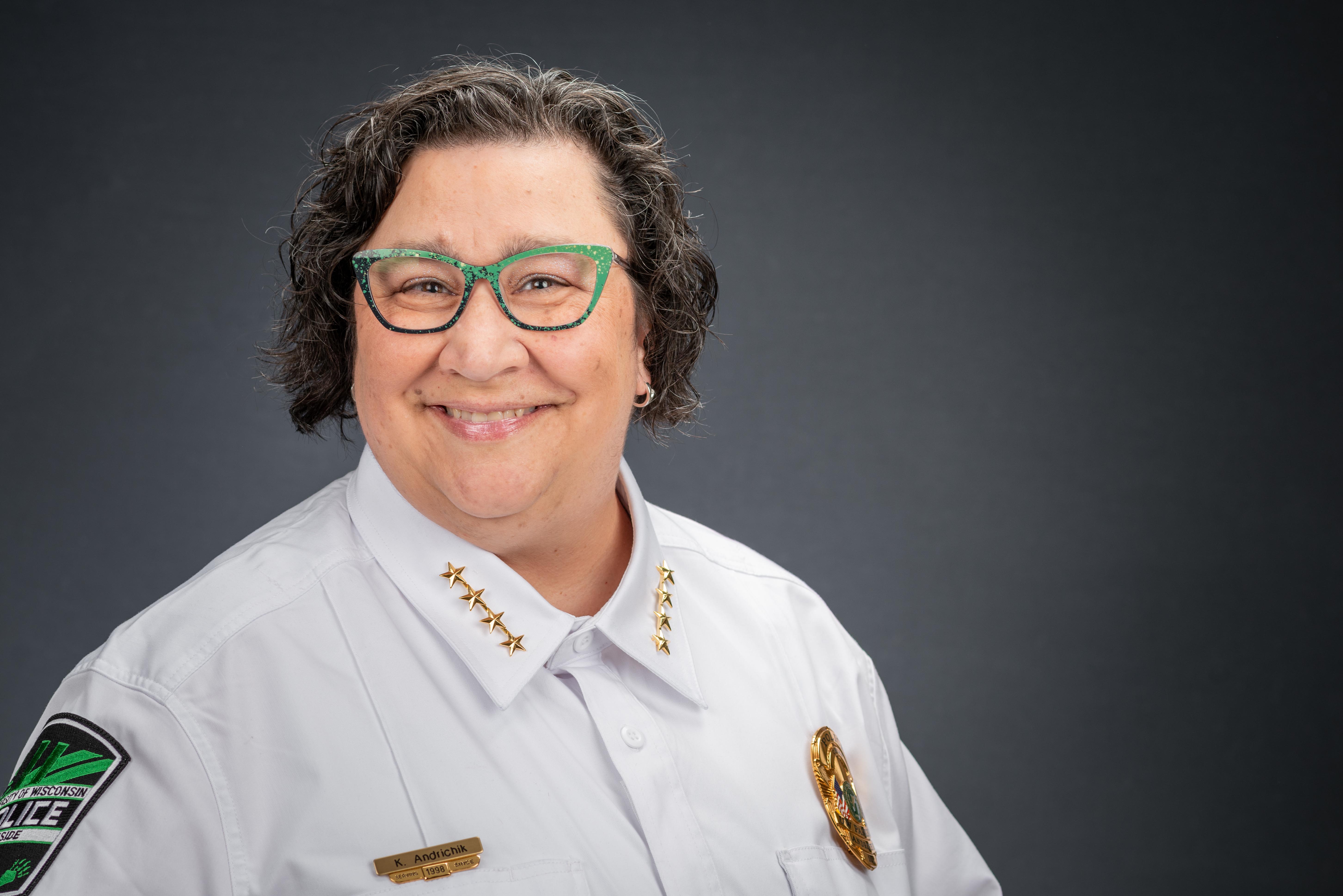 Latina woman with large frame glasses in green blazer