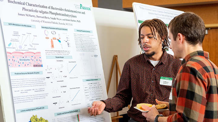 Image of two student's showcasing research during Student Showcase