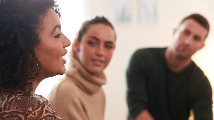 Image of a woman speaking to a group of young adults