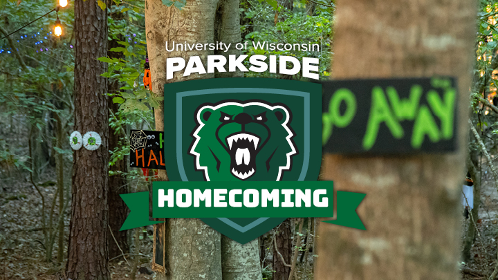 homecoming logo on a haunted trail in the woods