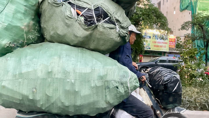 Decorative: Image of Vietnamese man on motorbike with lots of items