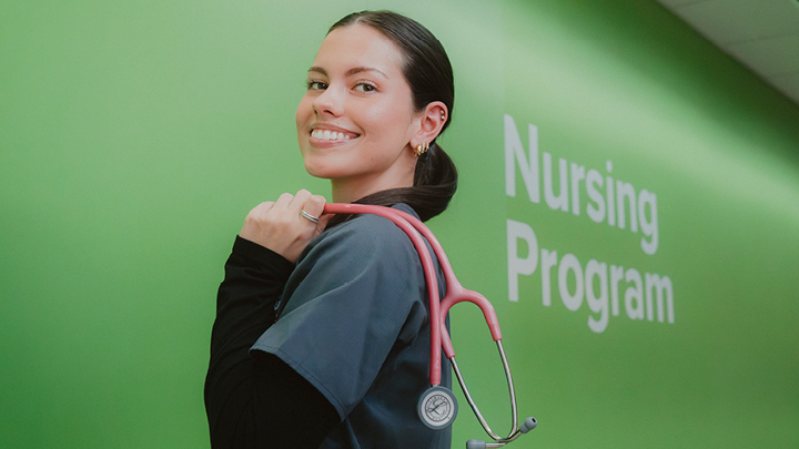 Image of nursing student smiling with a stethescope slung over shoulder