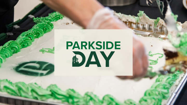 Parkside Day Logo in the background image of person cutting into UW-Parkside themed cake