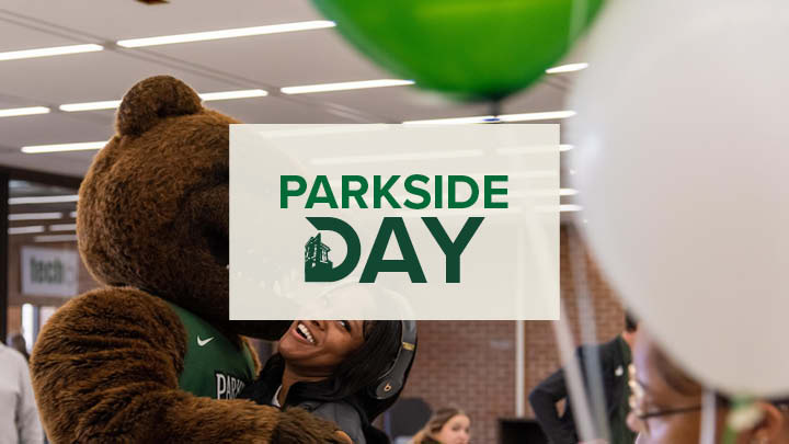 Parkside Day Logo in the background Ranger Bear hugging smiling student with balloons