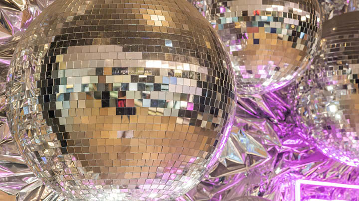 decorative image of shiny disco balls in purple background