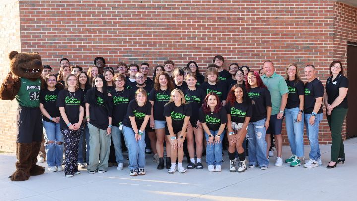 Callahan scholars smiling with the Callahan family and Ranger Bear outside of the sports and activities center