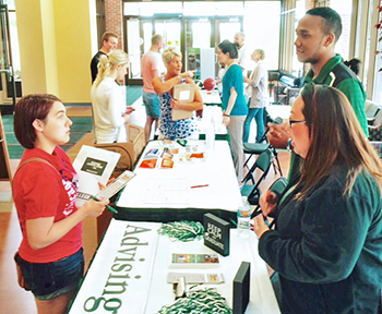 Transfer student talks with members of the Advising Center