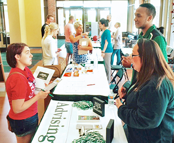 Transfer student talks with members of the Advising Center Transfer student talks with members of the Advising Center