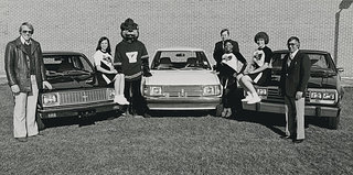 Students and Ranger Bear pose with the cars.