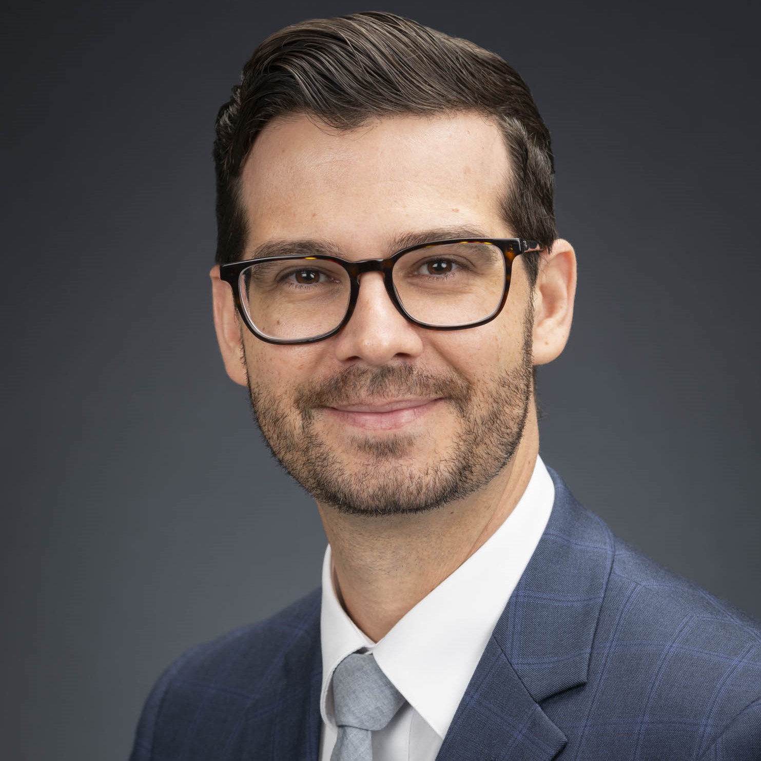 Man with brown hair and glasses