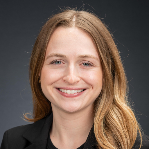 woman with brown hair smiling wearing a black shirt