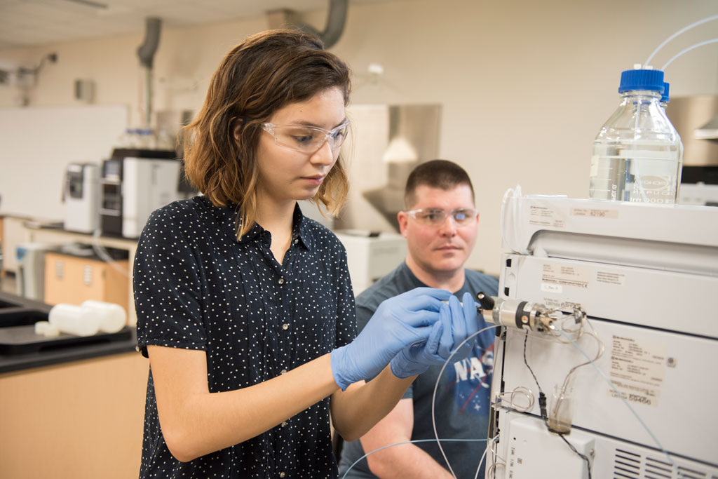 Chloe Calderon and Durwald Bevis in lab A male and female student working on new instruments in SCJ science lab