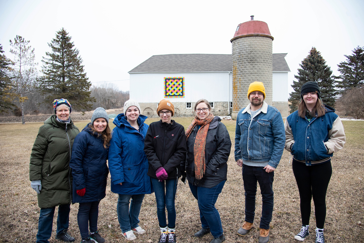 Students with Caitlin Curtis in front of a Barn Quilt