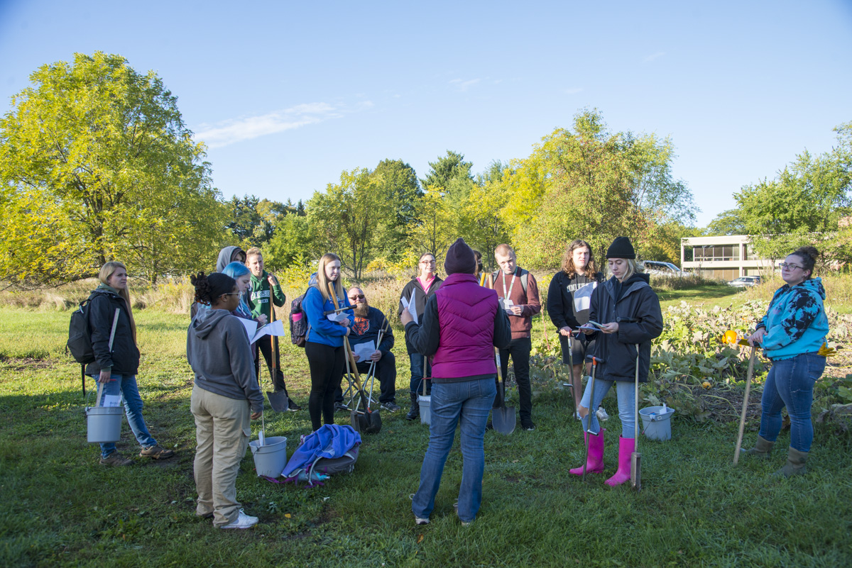 Enviromental Studies class does soil sampling in the community garden.