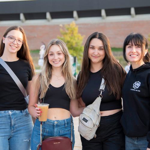 Group of girl students posing for the camera at Homecoming