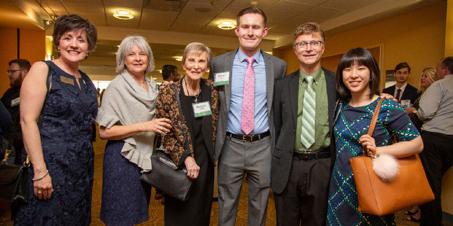 Chancellor Debbie Ford, Kristine Young Strange ’74, and family of Craig Young ’76