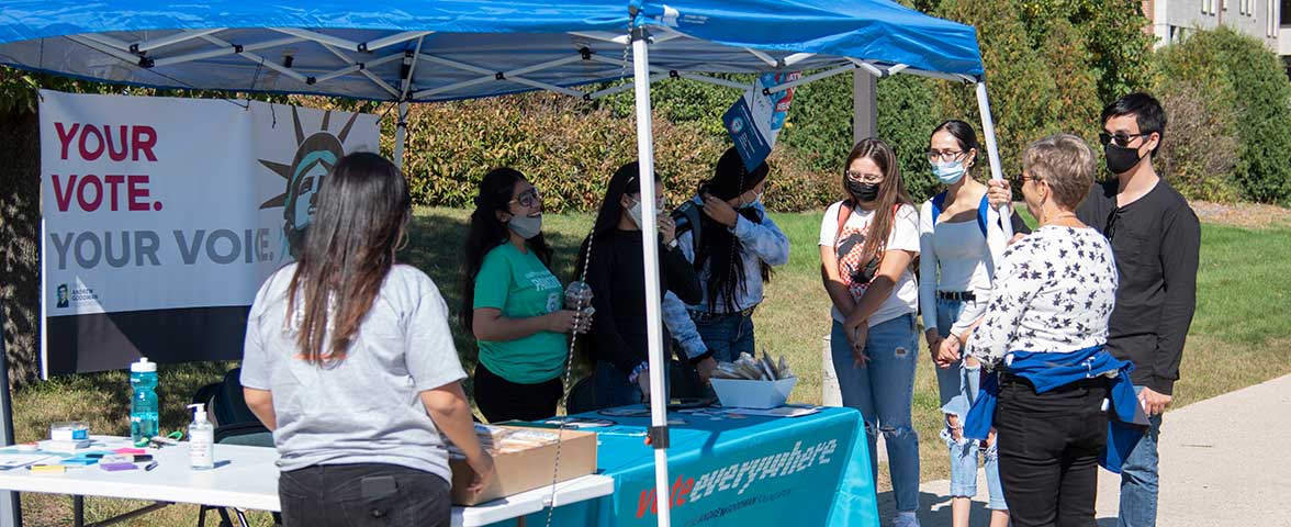 Students help other students register to vote on campus.