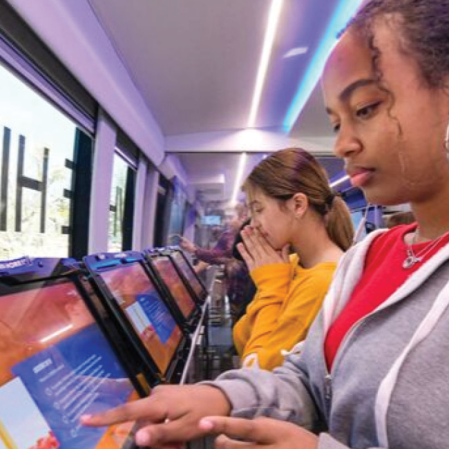 Cspan inside bus 650x650 Image of students doing research on computers on the CSPAn bus