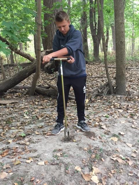 Student digging to find the water.