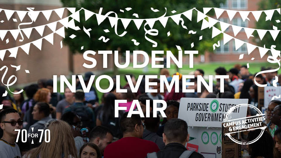 image of students outside on the concourse visiting various org  booths