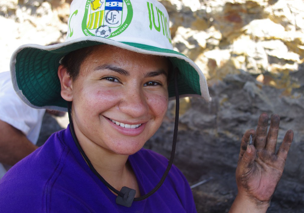 Melissa Acosta doing research holding a find