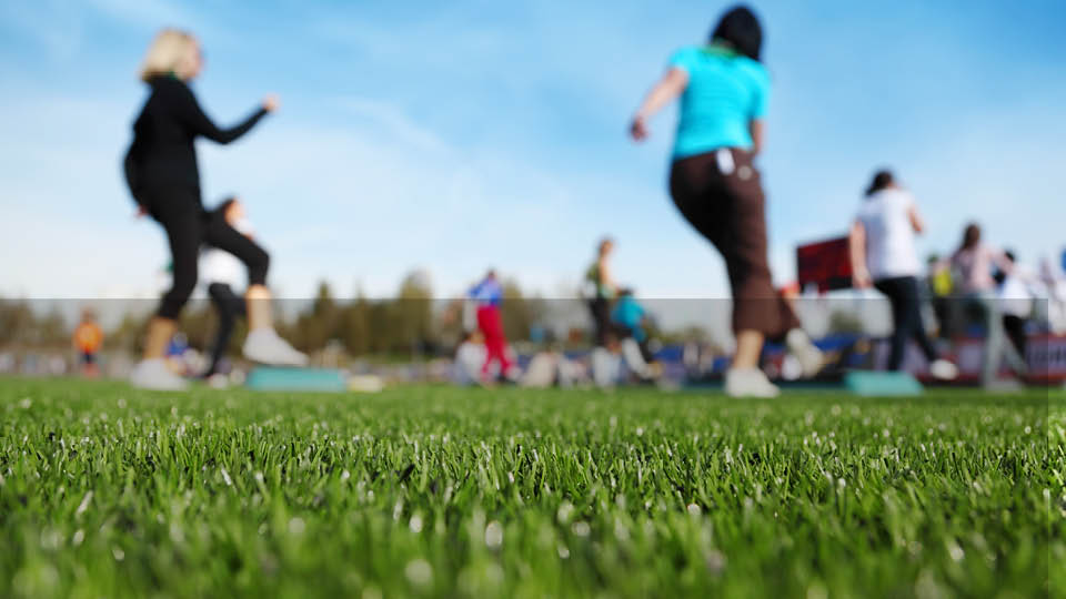 image of people exercising outdoors as a group