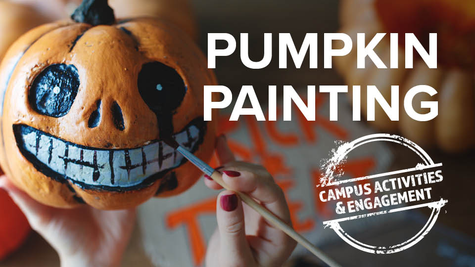 image of pumpkin in hand being painted with bruch