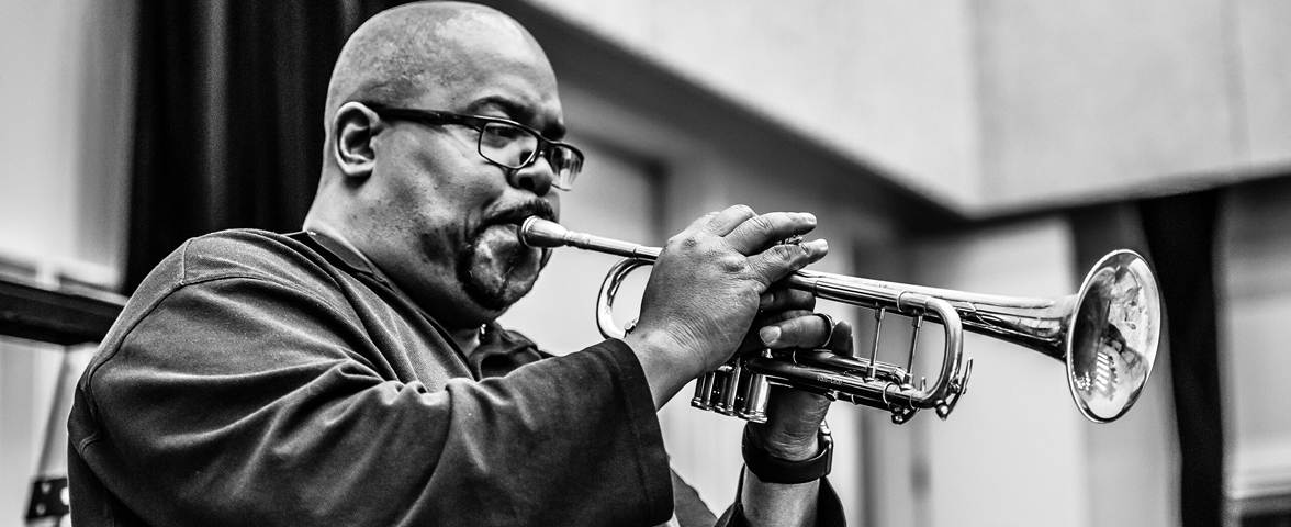 Derrick Gardner playing a horn