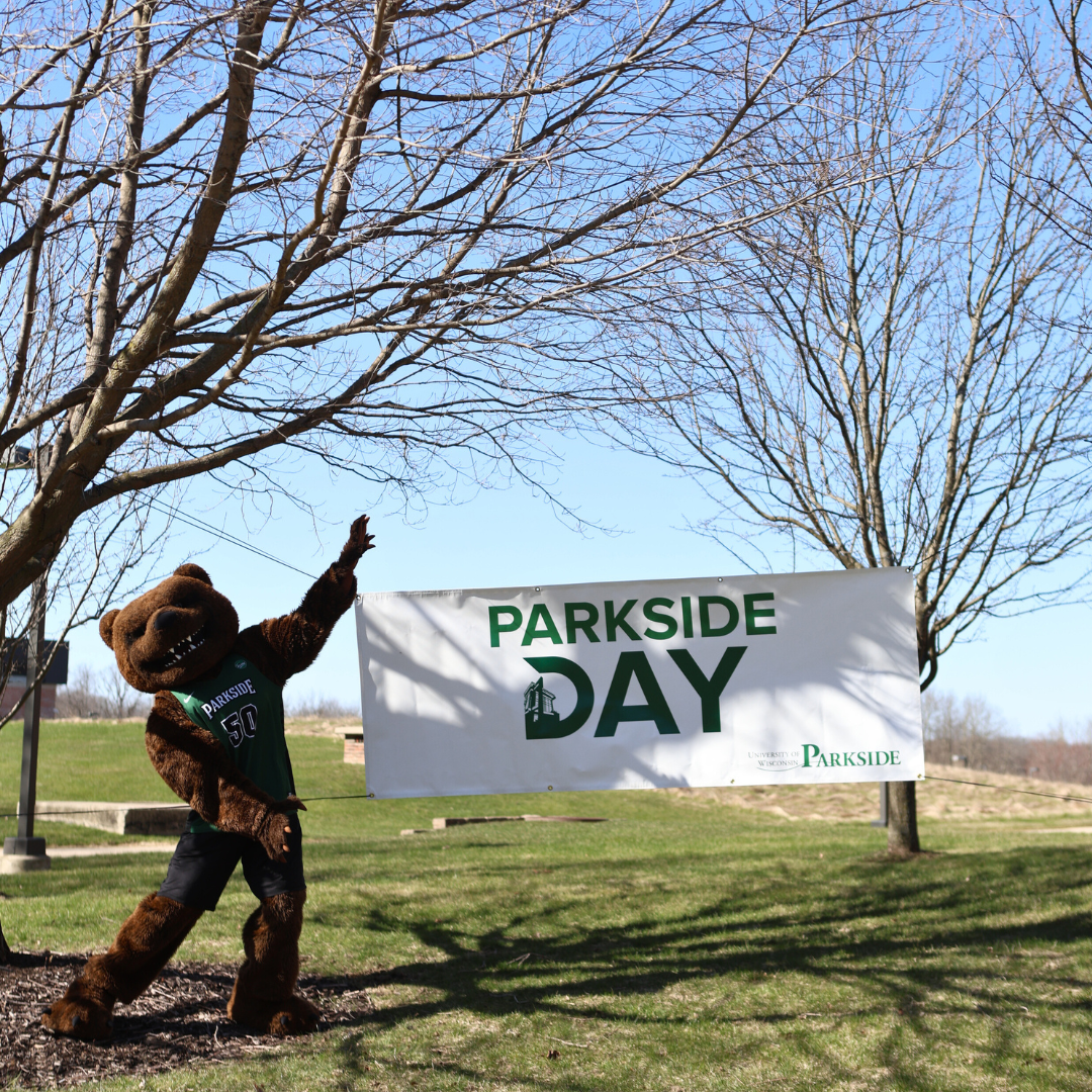Ranger Bear pointing at a sign outside that says "Parkside Day"
