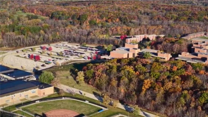 Drone shot of campus An aerial view of a university campus surrounded by autumn trees.