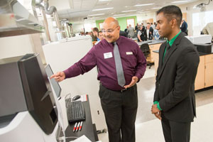 Siva Shankar of Kenosha talks with Shimadzu Engineer Delano Turner