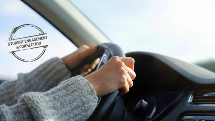 Photo of someone driving a car. A logo is on the image that says &quot;Student Engagement &amp; Connection&quot;