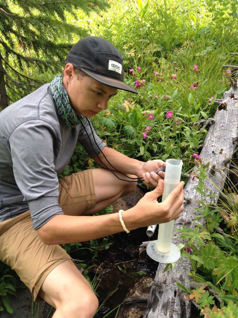 UW-Parkside student samples water from Root River