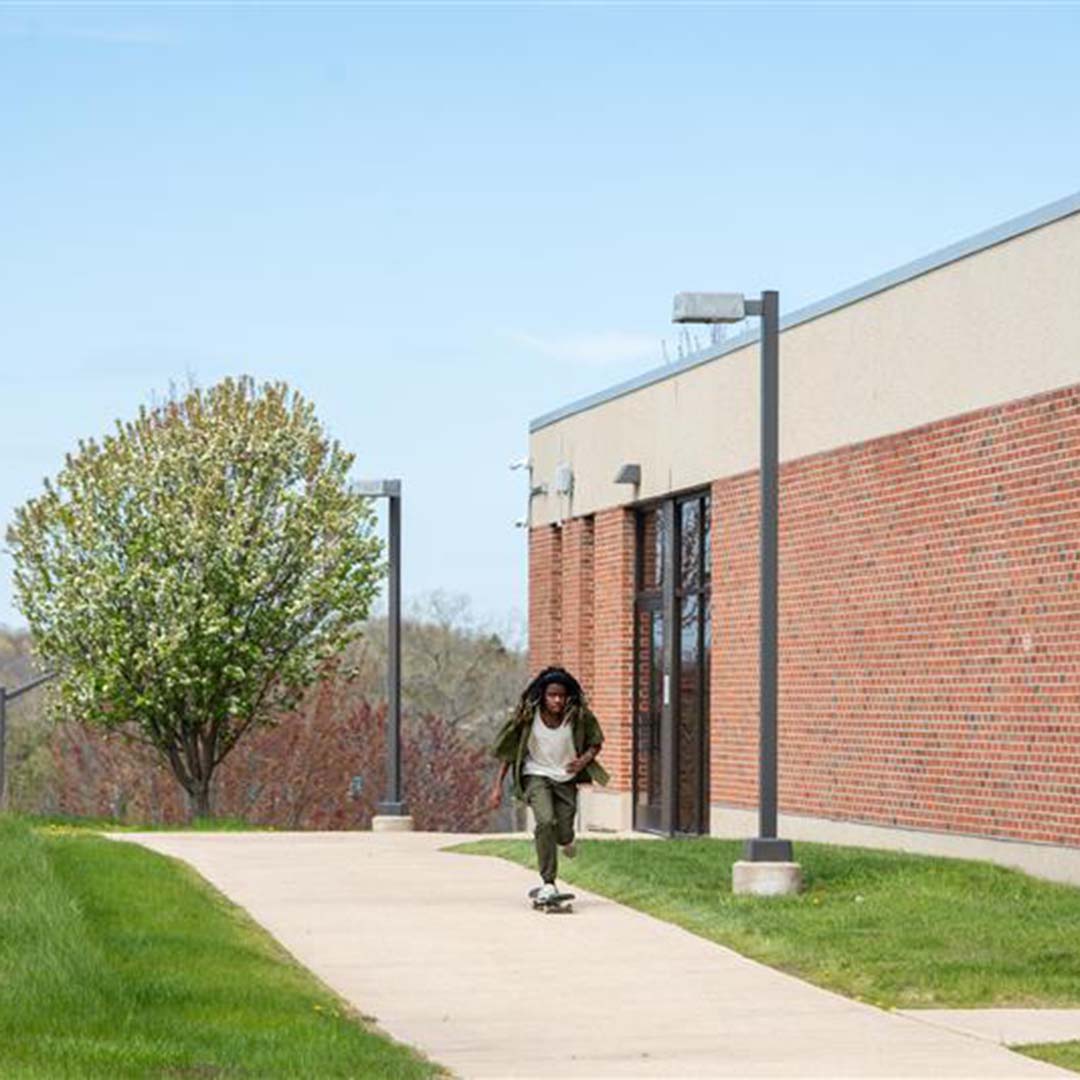 Jerome Porter skateboarding on campus
