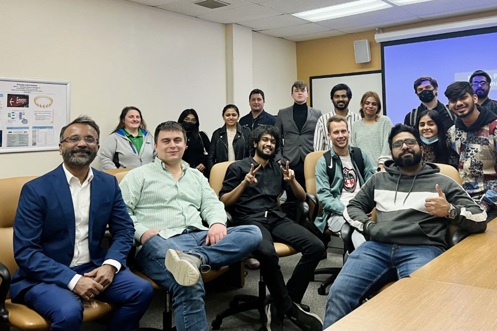 Dr. Abey Kuruvilla, far left, Nick Koenen, seated next to Dr. Kuruvilla, and the UW-Parkside MBA business operations class.