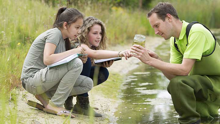 This image depicts two children and an instructor