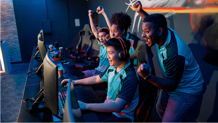 group of people gaming on desktop computers
