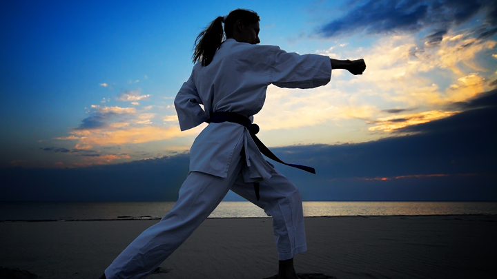 girl standing outside practicing karate