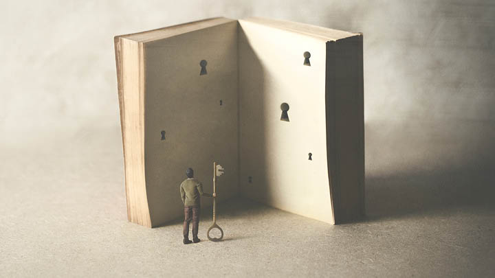 Surreal image of a man with a key standing by a large book
