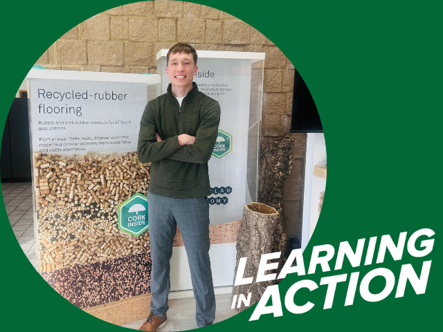 Learning in Action story for UW-Parkside student Lucas Sternberg standing in front of signs for recycled-rubber flooring, Spring 2026