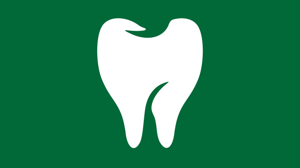 Icon of a tooth on green