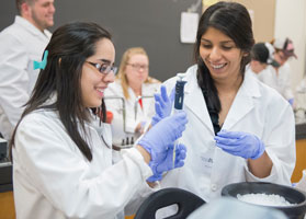 Two pre-health student performing an experiment