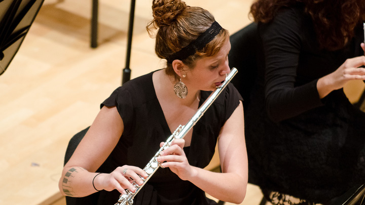 Student playing flute in Bedford Hall