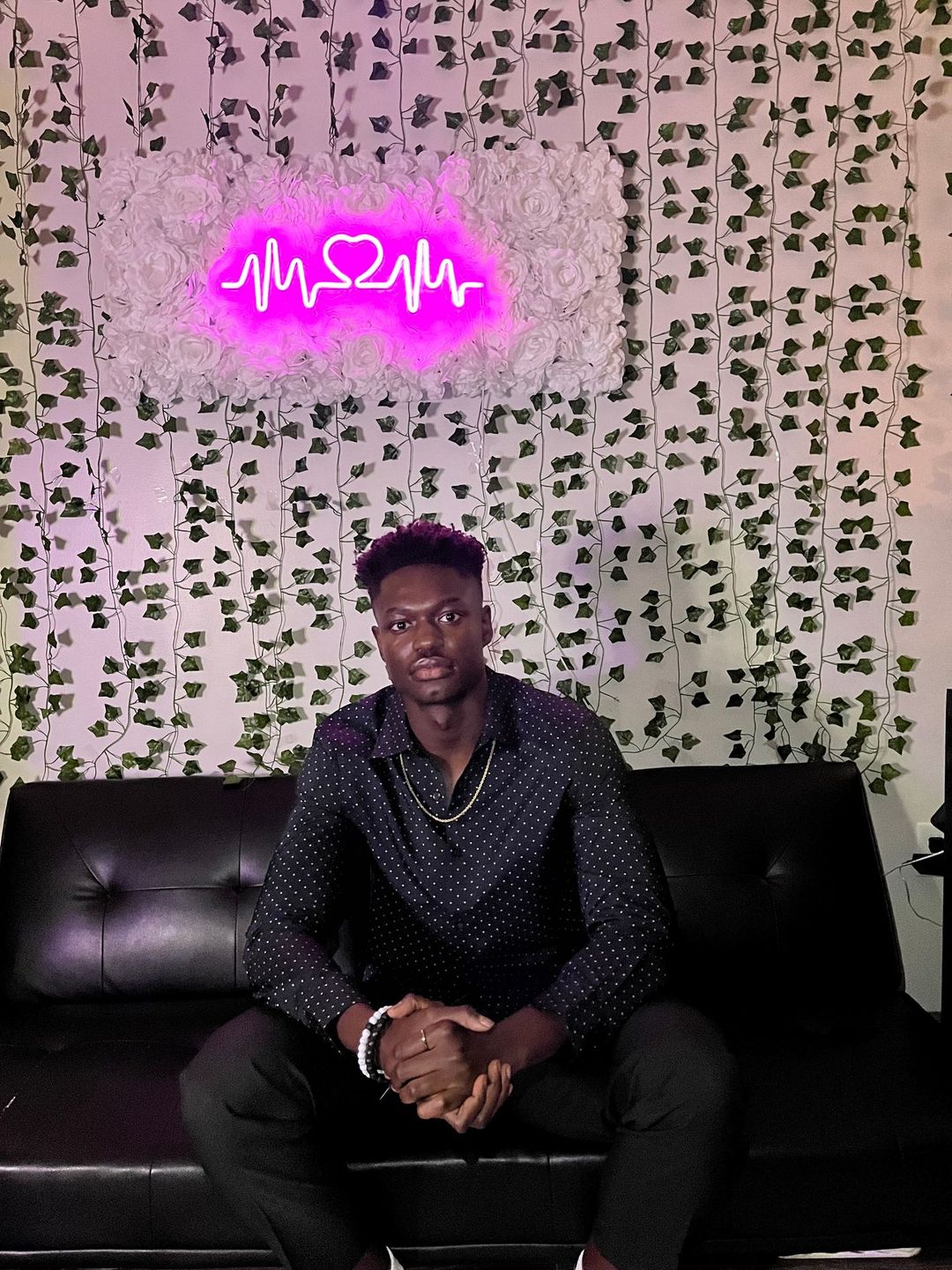 Photo of Boukary sitting in a family room