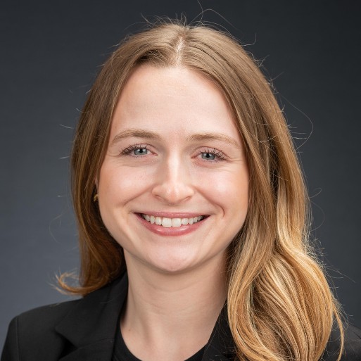woman with brown hair smiling wearing a black shirt