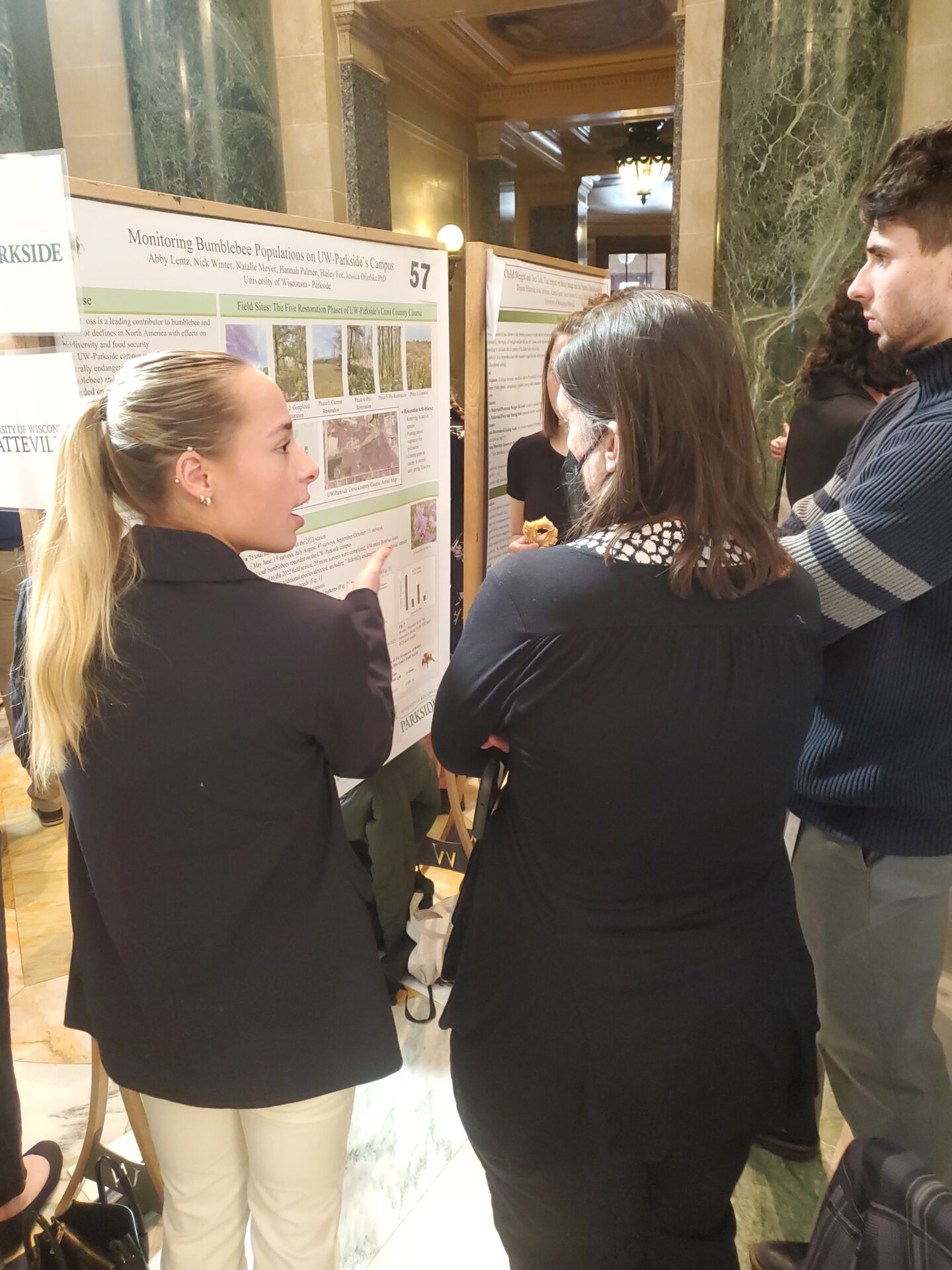 Abby Lentz (Left) discusses her research