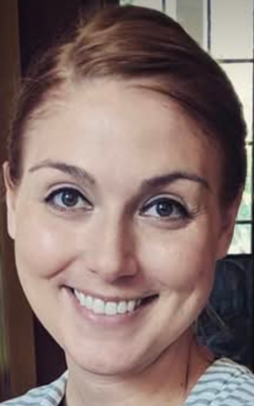 Headshot of woman smiling at a camera