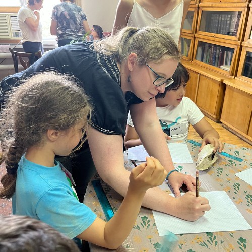 Dr. Caitlin Curtis Whitaker teaches two young students about archaeological drawing at the National Gallery of Armenia. Photo by Ris Homar