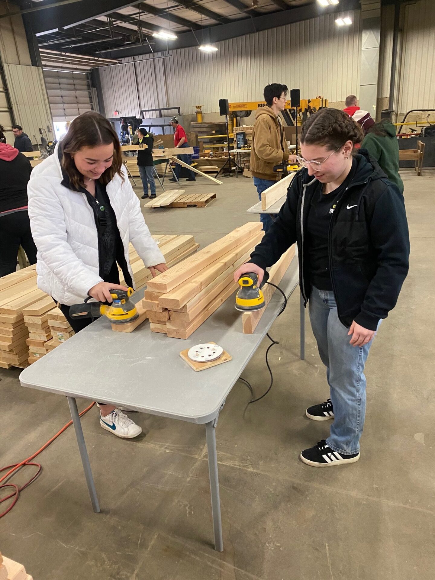 Callahan scholars Maddie Lallo (Left) and Judea Mahboub (Right) help build beds for kids.