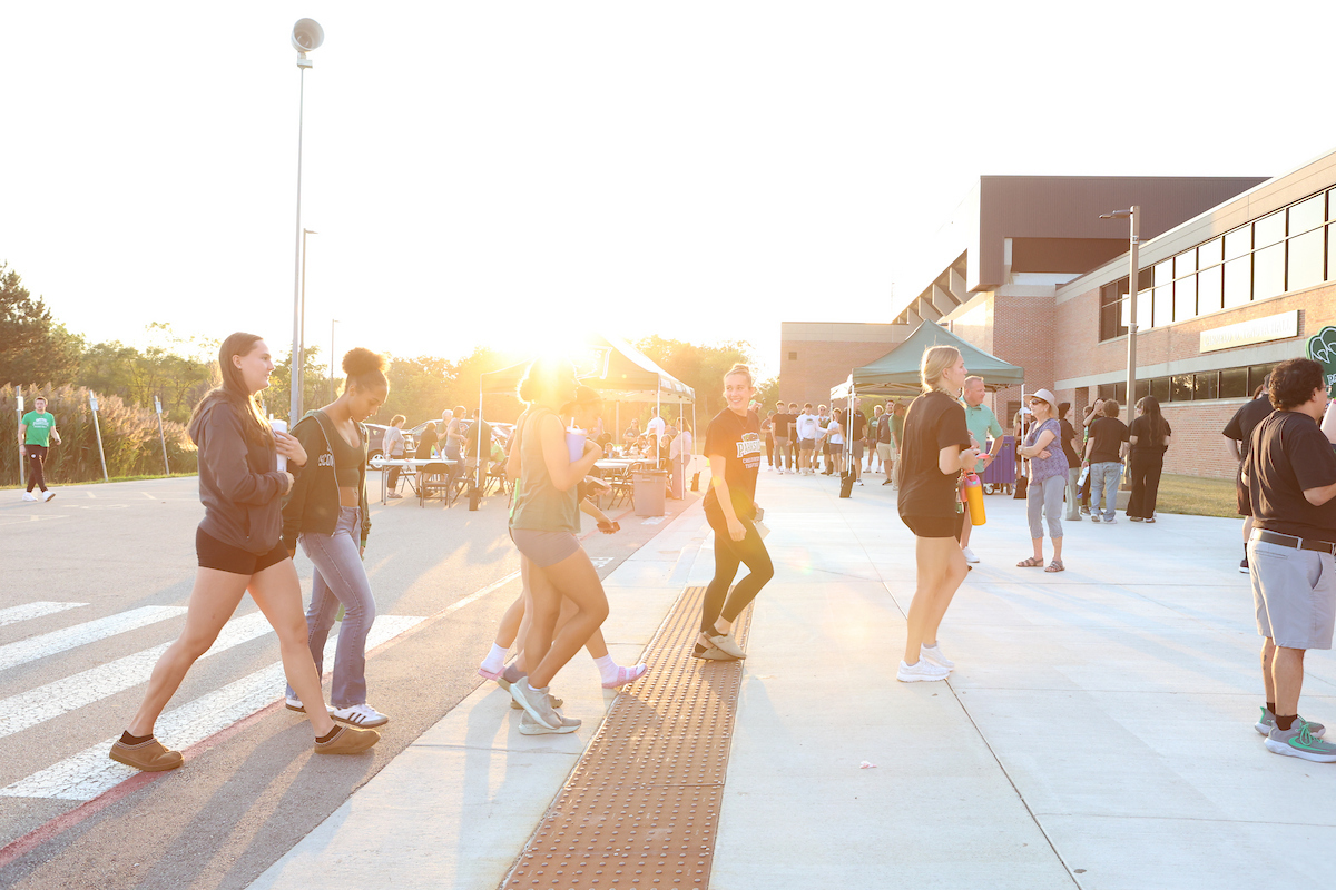 People walking to the SAC during sunset